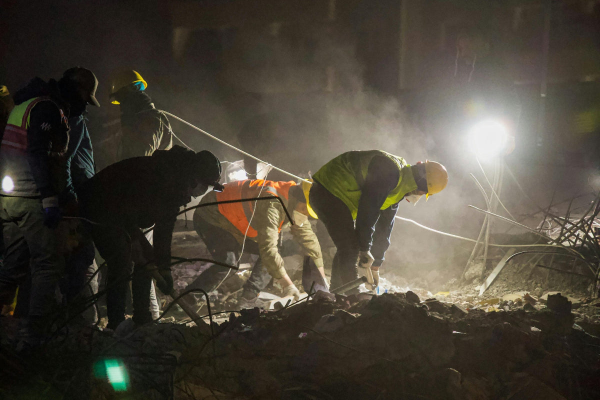 Emergency relief aid workers using HAVEN solar portable lantern to light up disaster zone after earthquake.