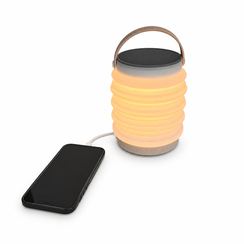 HAVEN 6000 3-in-1 Solar Portable Lantern, Flashlight and Power Bank Charging a Cell Phone