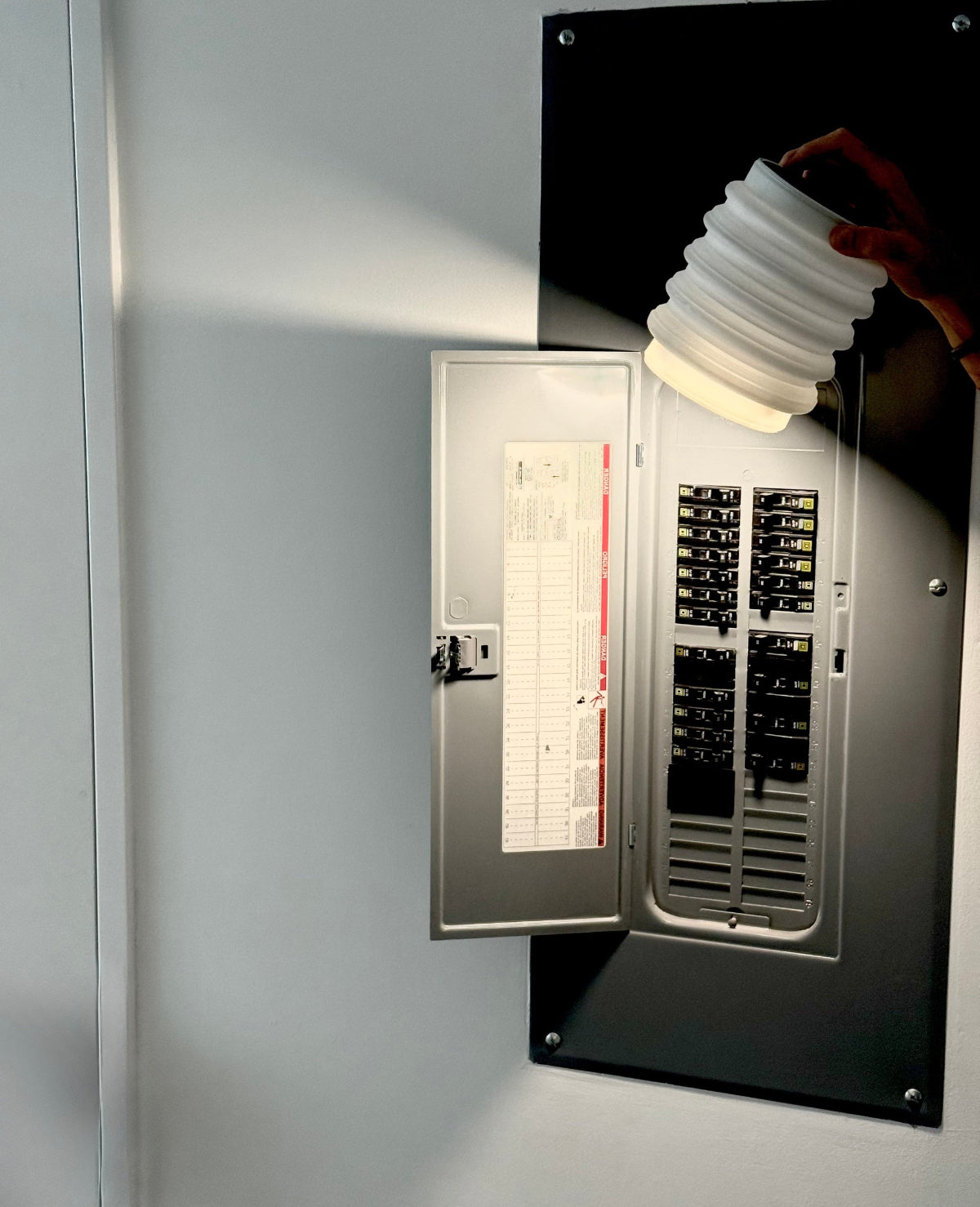 Electrical panel lit up by HAVEN portable solar flashlight during a blackout.
