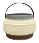 Product shot of HAVEN portable solar lantern collapsed with adjustable handle up.  