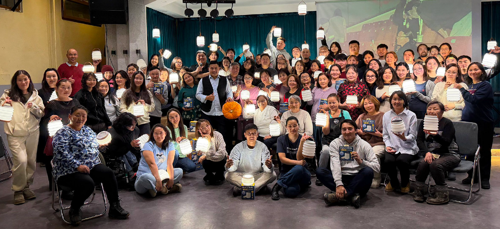 Group of people in Mongolia holding up HAVEN Lanterns.