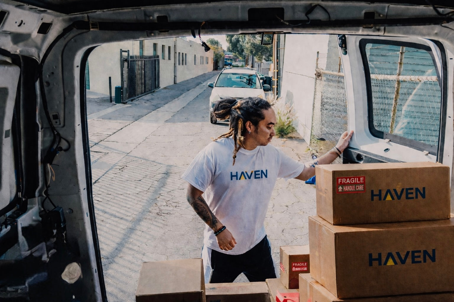 Volunteer unloading HAVEN solar portable lanterns and power banks and other disaster relief supplies after an emergency showcasing the power of corporations to engage in corporate social responsibility or CSR.
