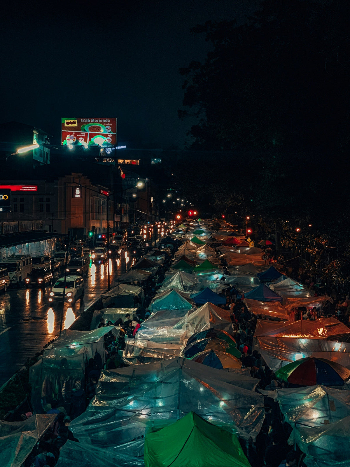 Refugee setting with illuminated tents  at night.