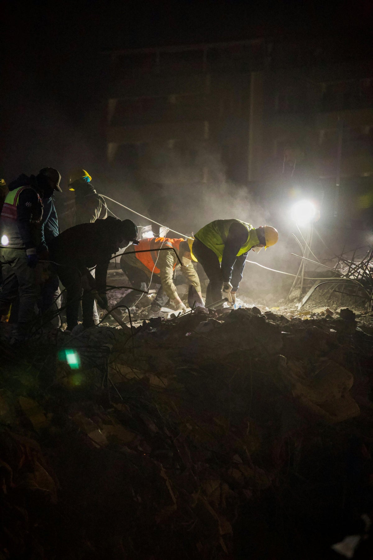Emergency relief aid workers using HAVEN solar portable lantern to light up disaster zone after earthquake.